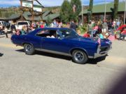 A thumb nail view of Grand Lake, Colorado during Constitution Week in September looking at vintage blue car rolling in the parade; click here to open a window with a larger picture.